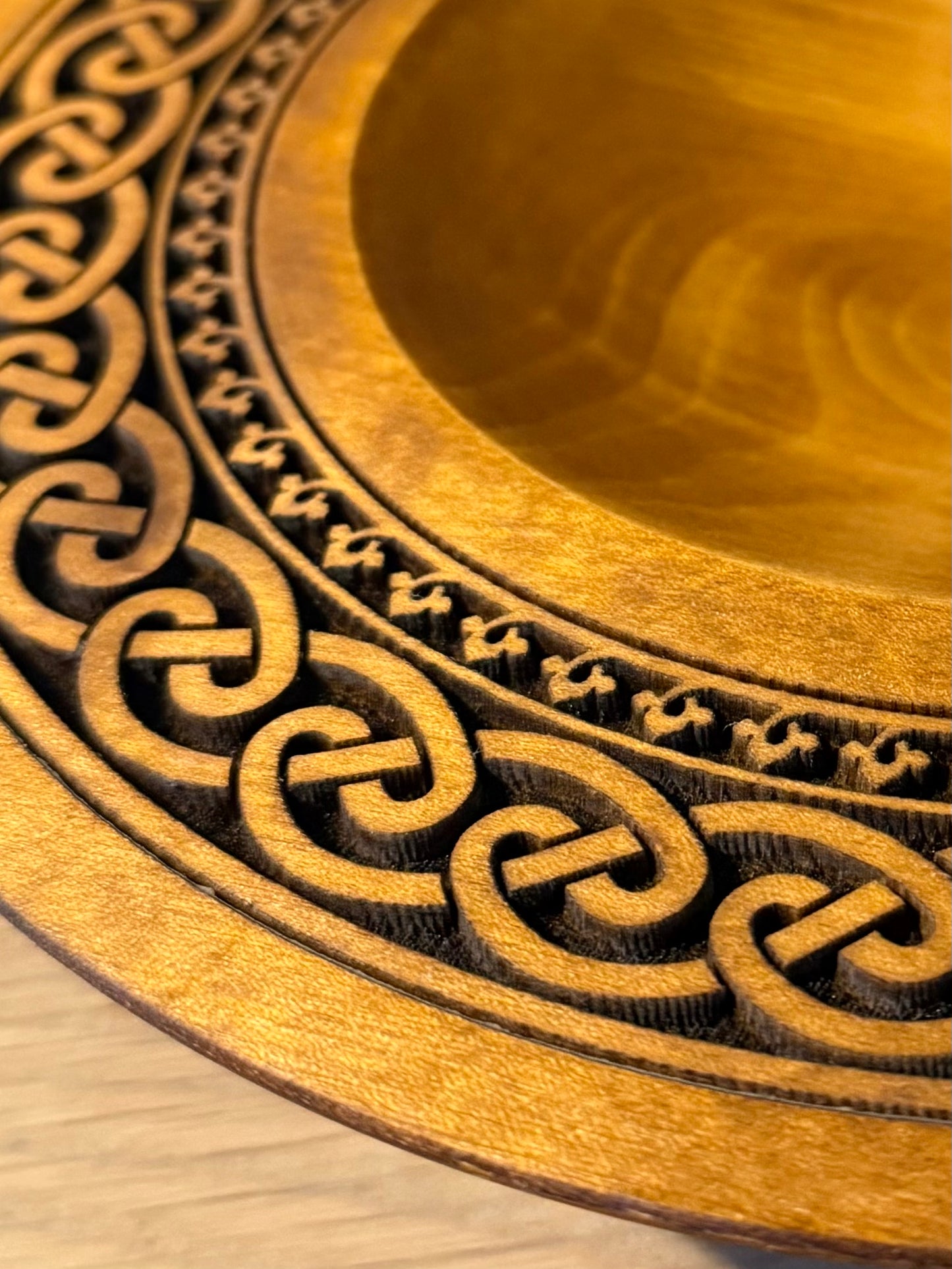 Turned teak-colored platter with Celtic border