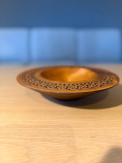 Turned teak-colored platter with Celtic border