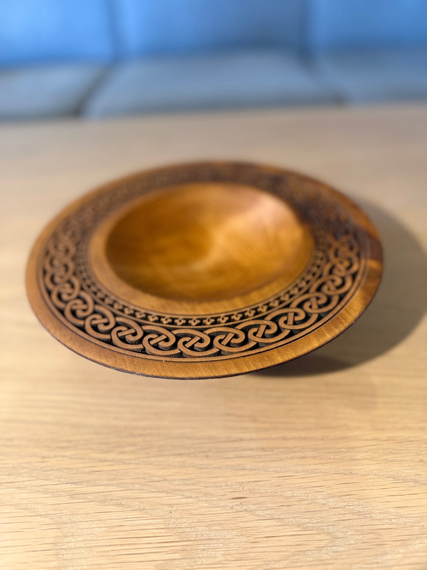 Turned teak-colored platter with Celtic border