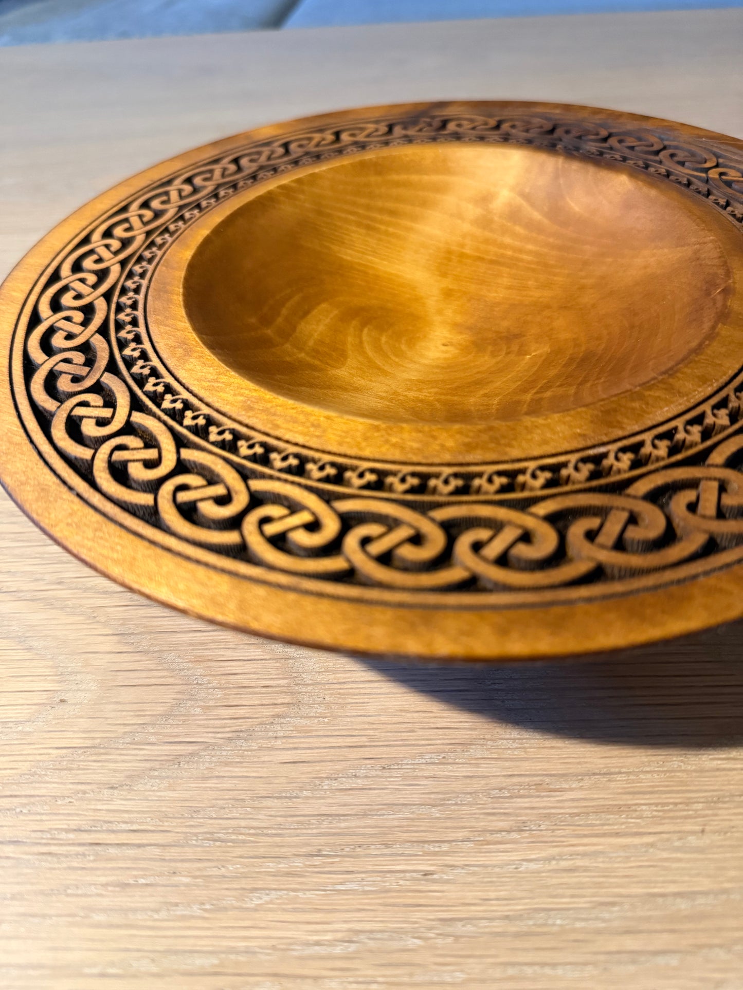 Turned teak-colored platter with Celtic border